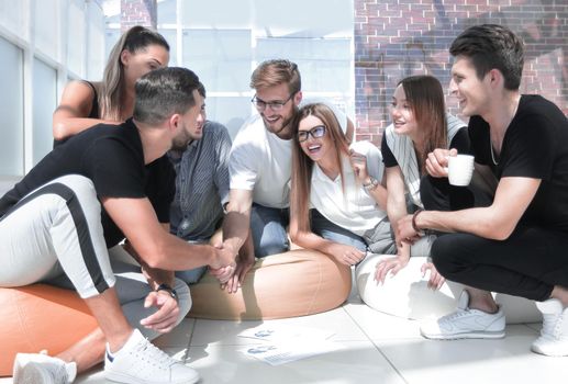 friends shaking hands when discussing a new project. the concept of a startup