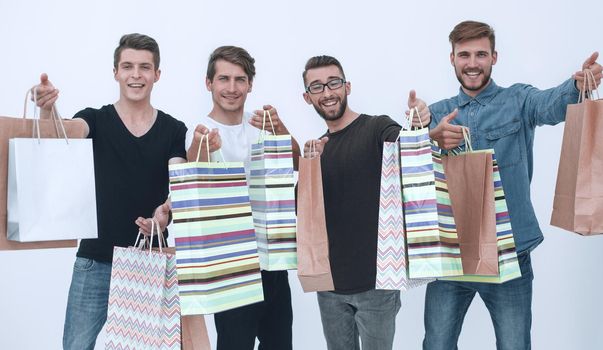 group of happy young friends with shopping bags.