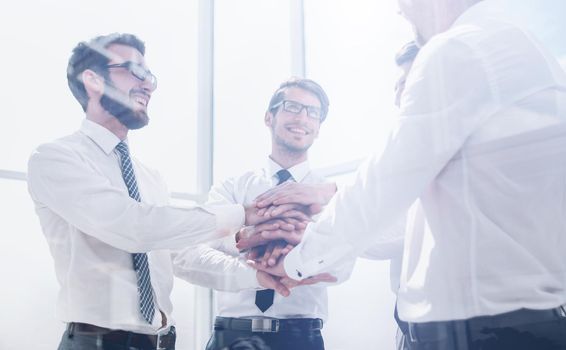 business colleagues folded their hands together.the concept of teamwork