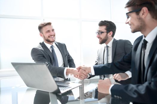 handshake employees at the Desk.the concept of cooperation