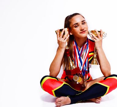 young smiling cheerleader girl with golden cups and price medals isolated on white background, lifestyle sport people concept close up