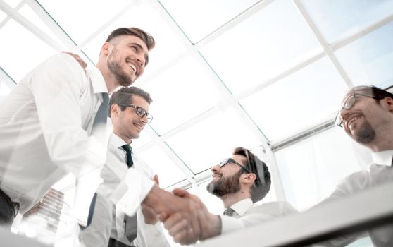 bottom view. handshake employees over the Desk.the concept of teamwork