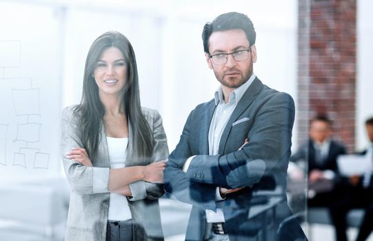 businessman and businesswoman look through the window of a modern office.photo with copy space