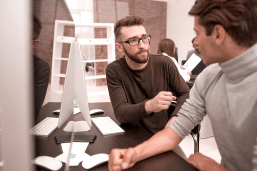 business team is discussing something sitting at the Desk.business concept