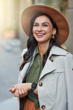 Fashion and beautiful people. Vertical shot of attractive happy stylish woman wearing grey coat and hat looking aside and smiling while standing on the city street, enjoying walking on warm autumn day