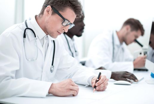 experienced doctor sitting at the laboratory table.the concept of health