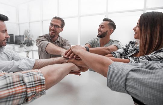 close up.business team folded their palms together, over the Desk.the concept of team building