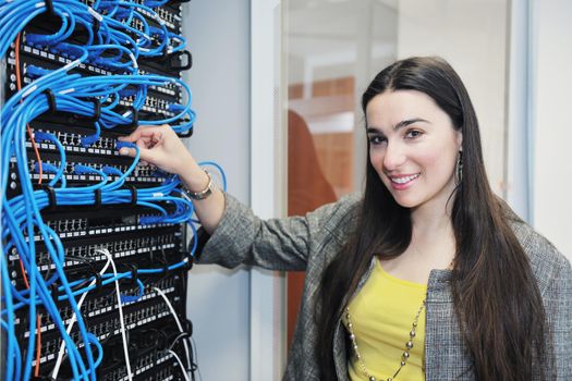 woman it engineer in network server room solving problems and give help and support