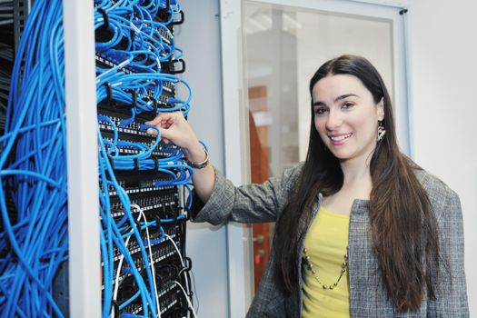 woman it engineer in network server room solving problems and give help and support