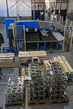 The first phase of metal and aluminum processing. Processed products from CNC machines stacked on a pallet in a large modern factory. High quality photo