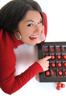 young woman isolated on white in red shirt eat sweet tasty chocolate