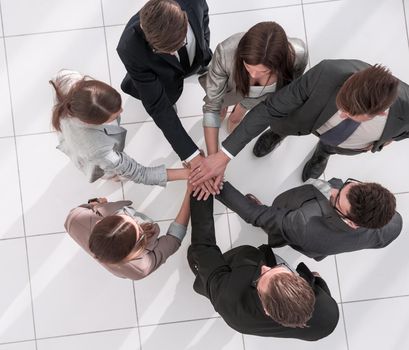 top view.a group of employees standing in a circle.the concept of teamwork