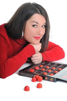 young woman isolated on white in red shirt eat sweet tasty chocolate