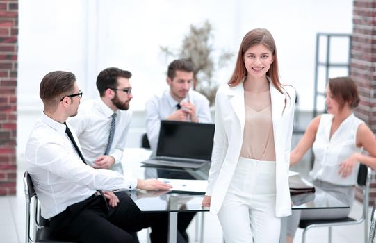 young business woman standing near her Desk.the concept of teamwork