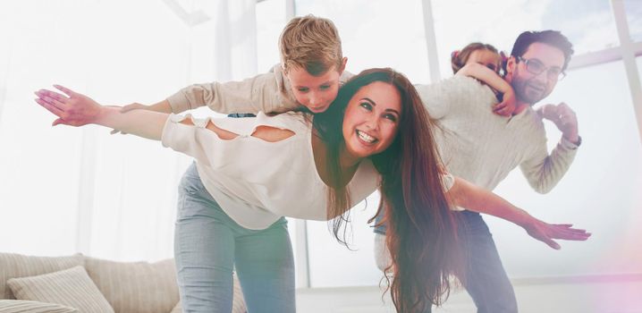 happy parents play with their children in the spacious living room.photo with copy space