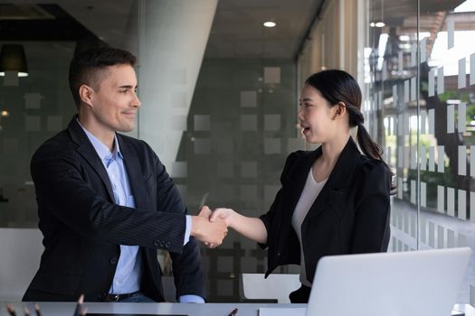 Businessman and partner handshake for the new agreement after sign in agreement contract with work together