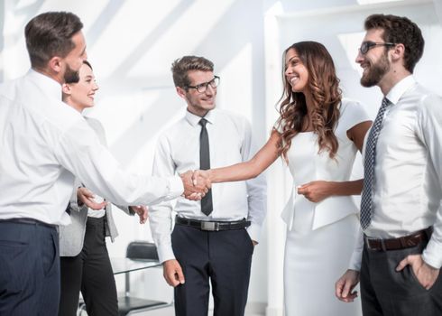 handshake between a businessman and a young businesswoman in the office.the concept of cooperation