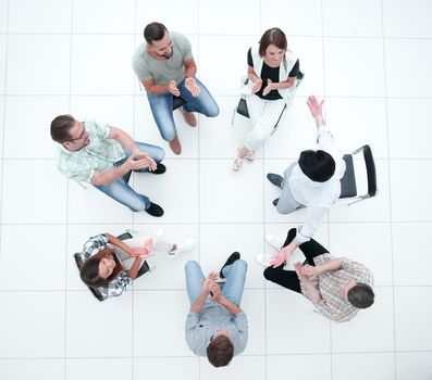 top view.the business team applauds their success.the concept of teamwork