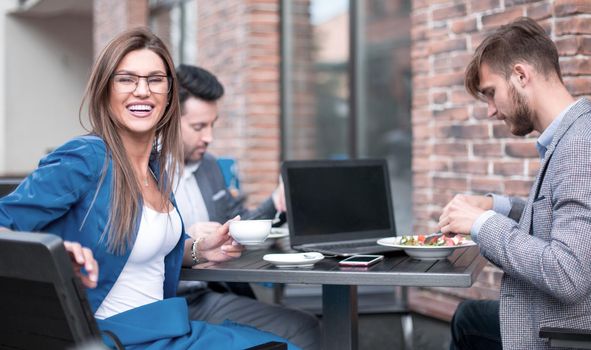 employees sitting at a table in a cafe.office weekdays