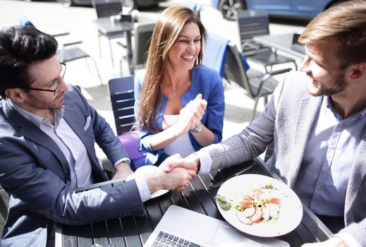 Two men shaking hands in cafe.business concept