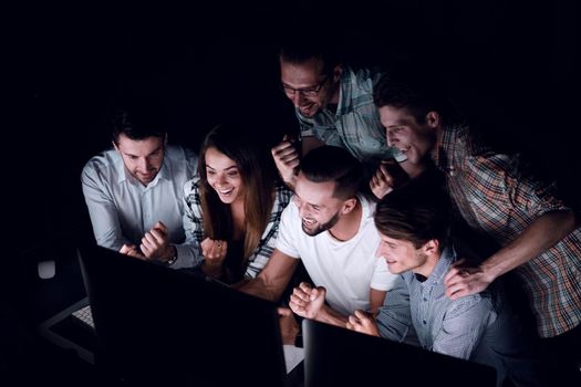 happy business team looking at computer monitor.the concept of teamwork