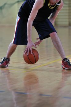 one healthy young  man play basketball game in school gym indoor