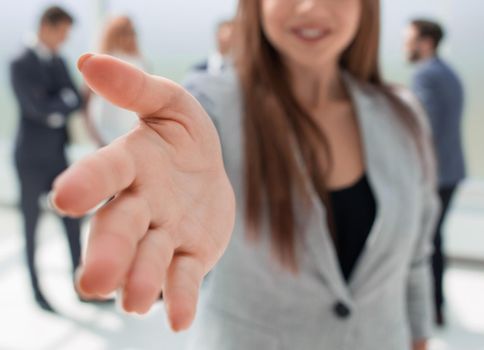 successful businesswoman holding out her hand for a handshake.concept of cooperation