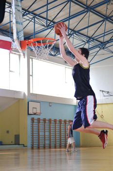 one healthy young  man play basketball game in school gym indoor