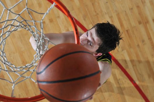 one healthy young  man play basketball game in school gym indoor