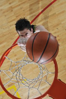 one healthy young  man play basketball game in school gym indoor