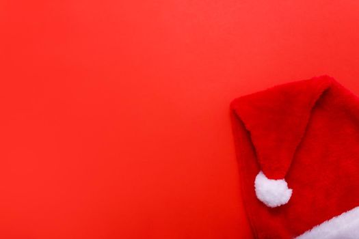 Santas hat on red christmas background with copy space for text