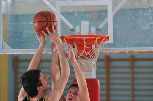 competition cencept with people who playing basketball in school gym 