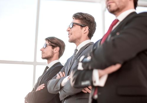 side view of a group of confident businessmen looking at a copy space.close up