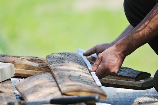 manual wood worker wirking with chainshaw closeup