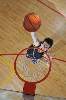 one healthy young  man play basketball game in school gym indoor