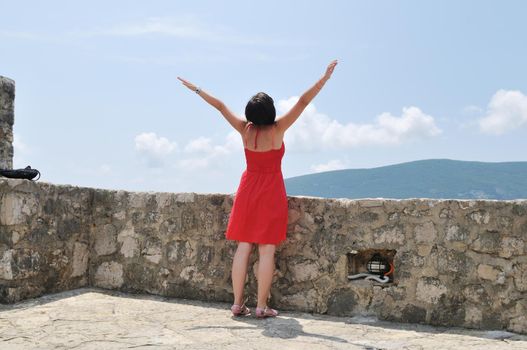 young happy woman with arms wide open representing freedom concept 