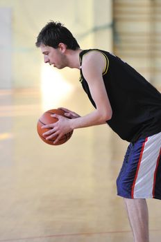 one healthy young  man play basketball game in school gym indoor