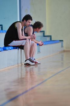 basketball players reslax and rest after hard game