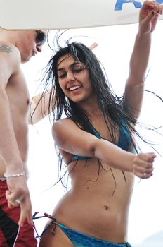 young happy people have fun and dancing on beach at sumer time with rain