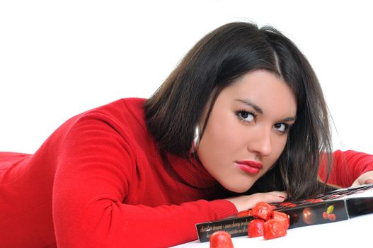 young woman isolated on white in red shirt eat sweet tasty chocolate