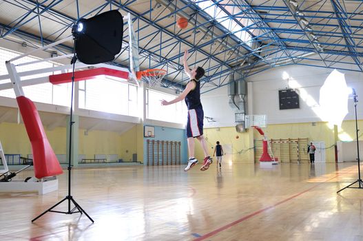 one healthy young  man play basketball game in school gym indoor