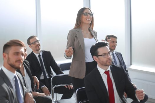 business woman asks a question standing in the conference room. business meeting concept