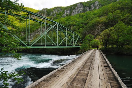 beautiful bridge in nature over wild river