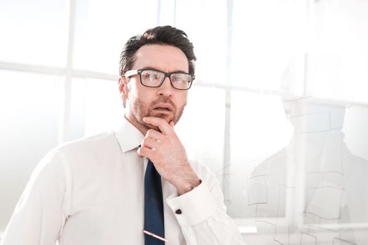 serious brooding businessman standing in the office.business concept