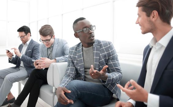 employees of the company are talking sitting in the lobby of the office.business concept