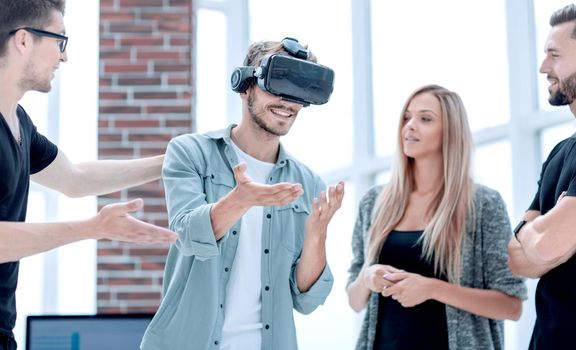 Young male software programmer testing a new app with 3d virtual reality glasses in office