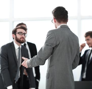 rear view. businessman standing in the office.business concept