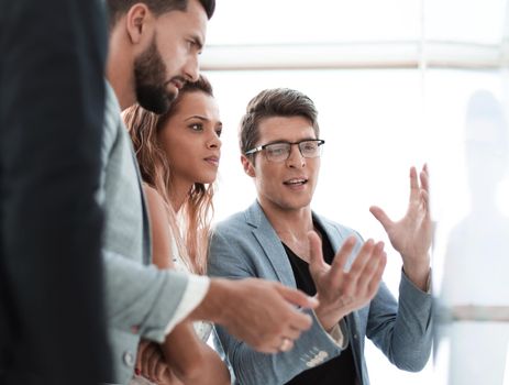 close up.business team talking, standing near the flipchart.photo with copy space