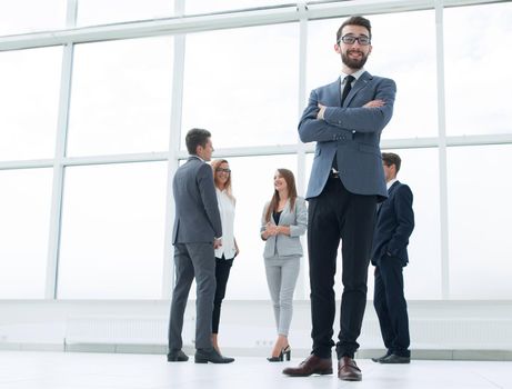 bottom view.successful businessman standing in a bright office.photo with copy space