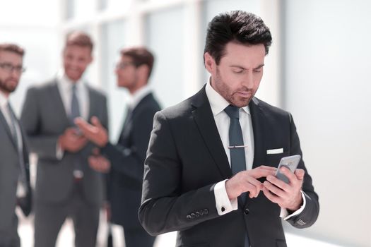 businessman looking at the smartphone screen .people and technology